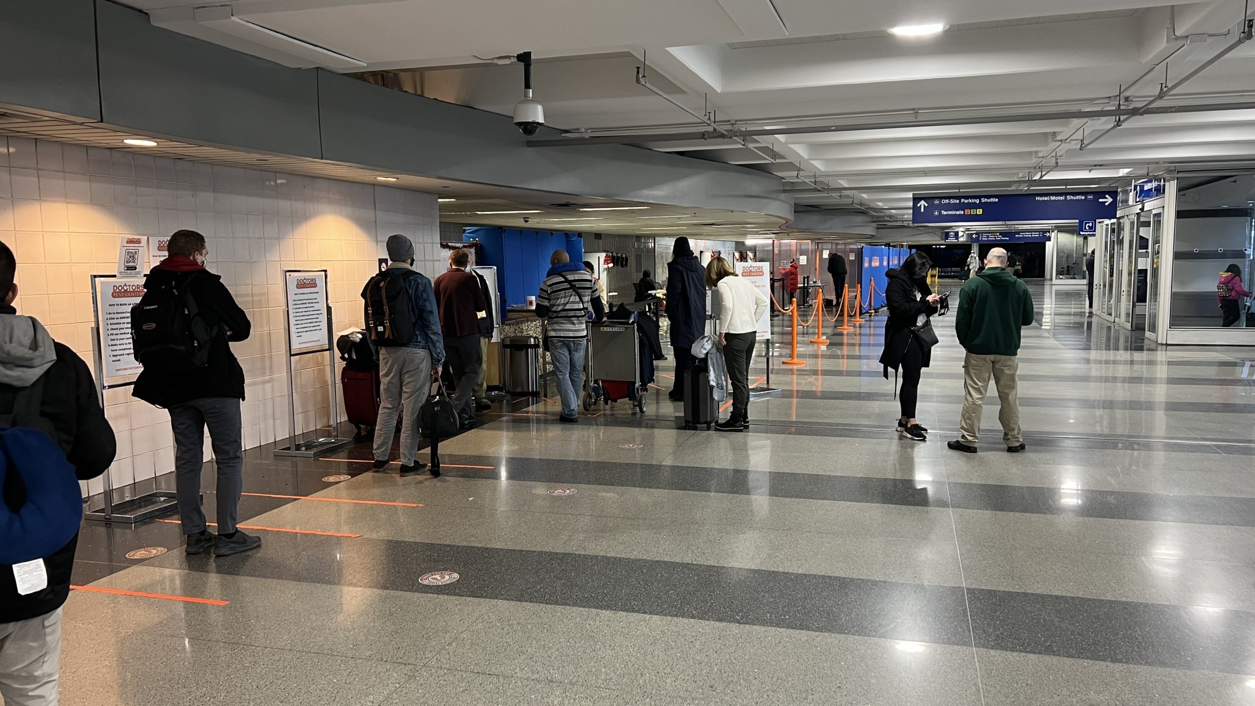people standing in a line in a airport