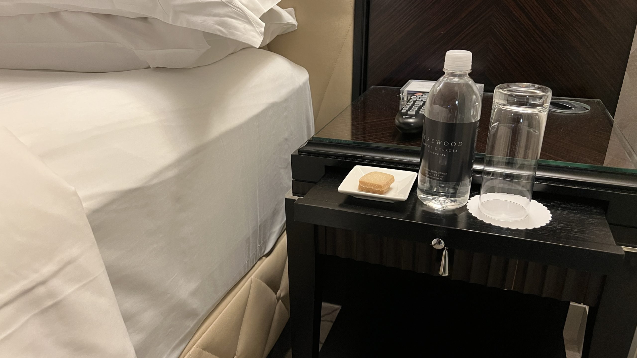 a table with a bottle of water and a plate of food on it
