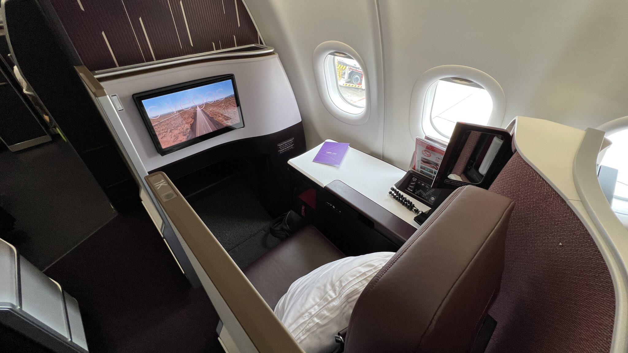 a desk with a computer and a monitor on the side of the plane