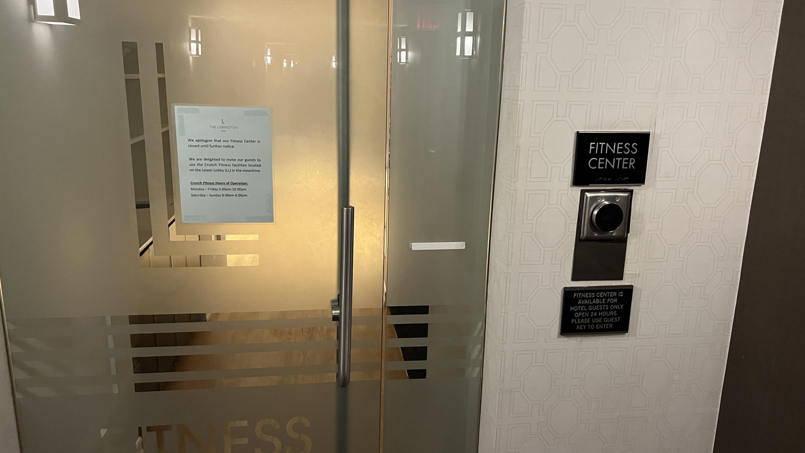 a glass door with a sign on the wall