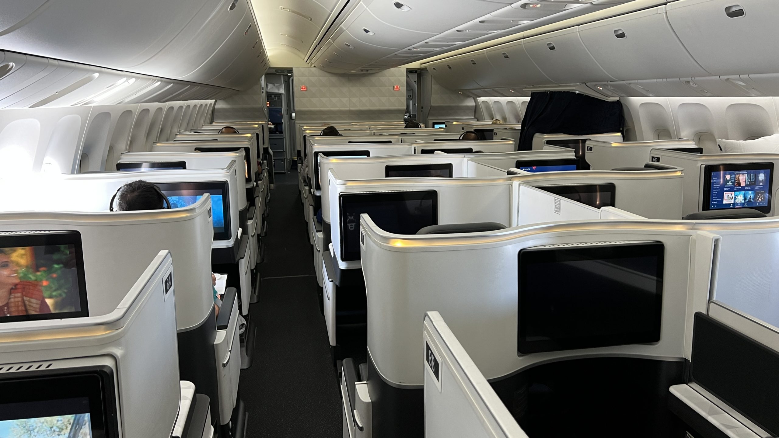 an airplane with rows of seats and monitors