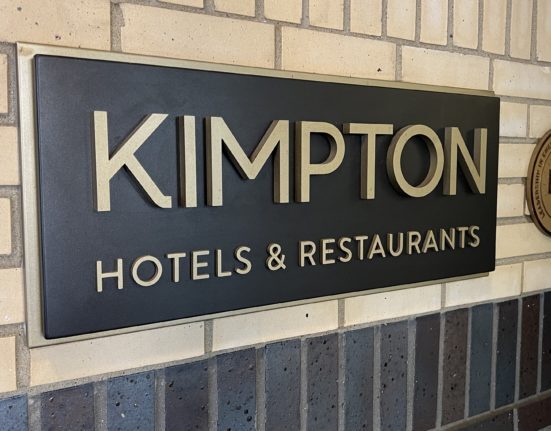 a sign on a brick wall