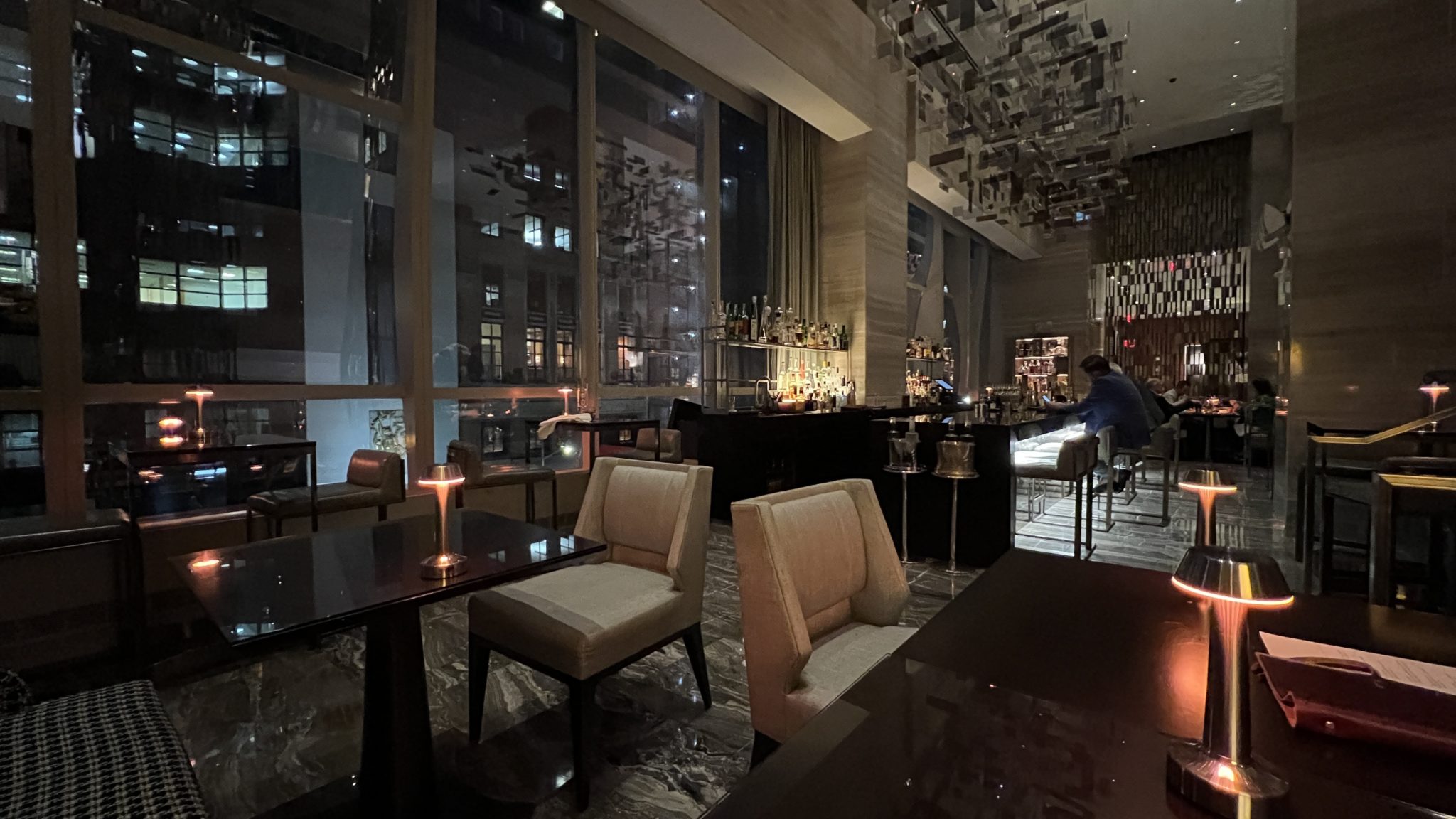 a room with a bar and chairs