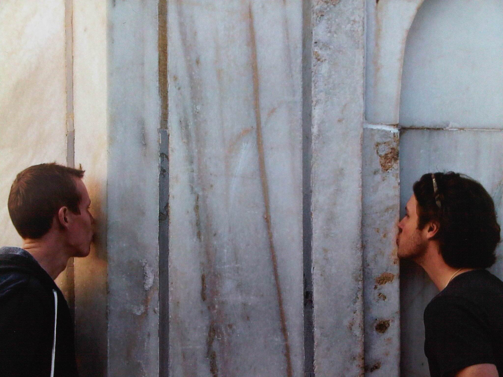 two men kissing each other