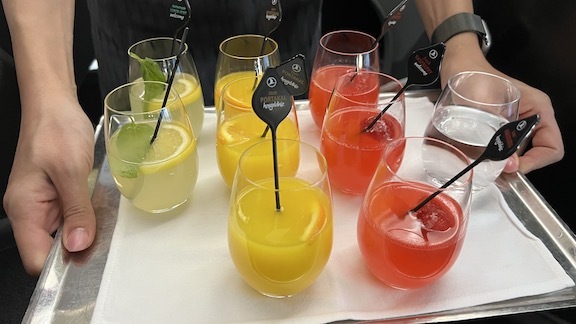 a group of glasses with different colored drinks