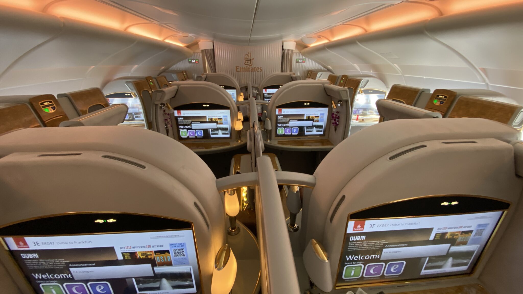 the inside of an airplane with seats and screens