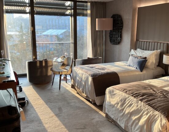 a room with two beds and a table