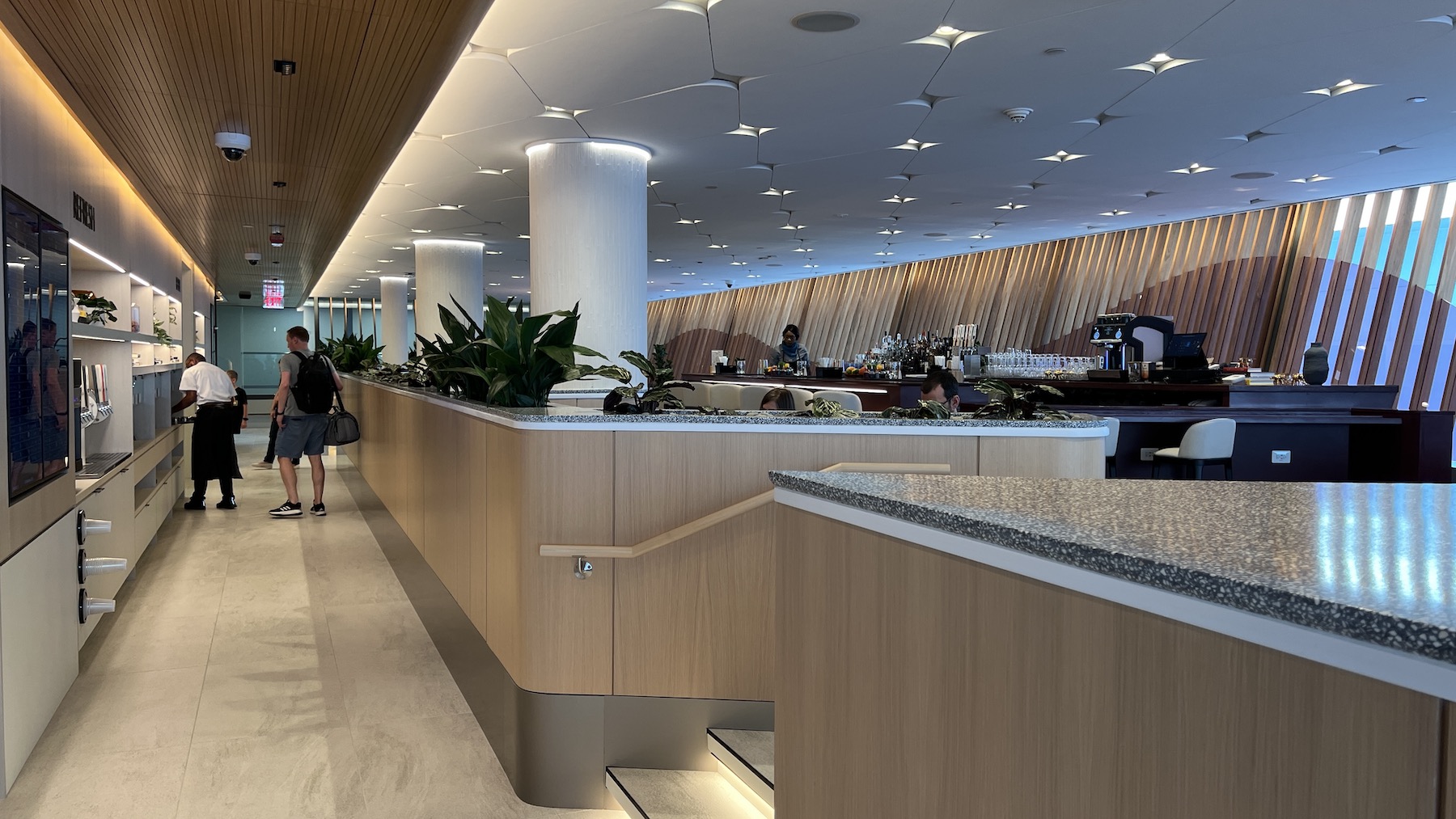 a large room with a counter and people