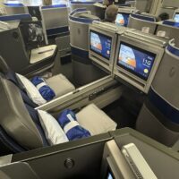 a seats with monitors and a couple people in the background