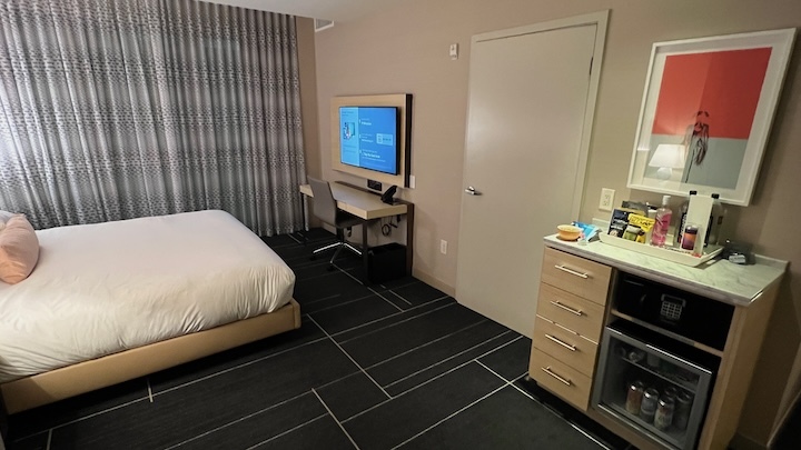a room with a bed and a television
