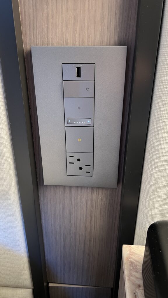 a rectangular electrical outlet with buttons and a usb port