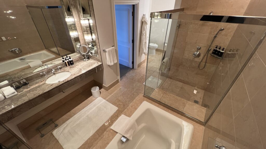 a bathroom with a glass shower and a bathtub