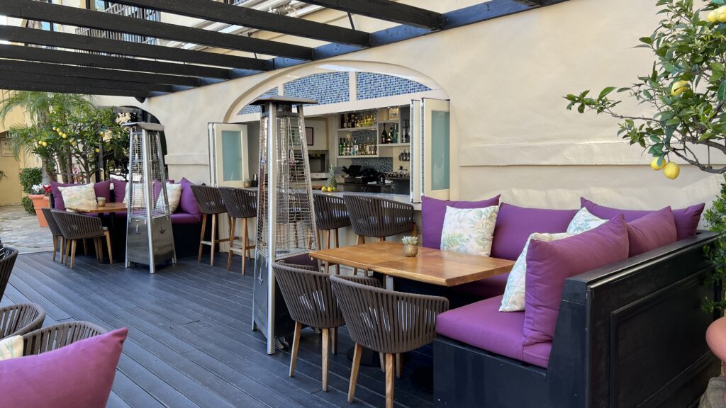 a patio with purple couches and chairs