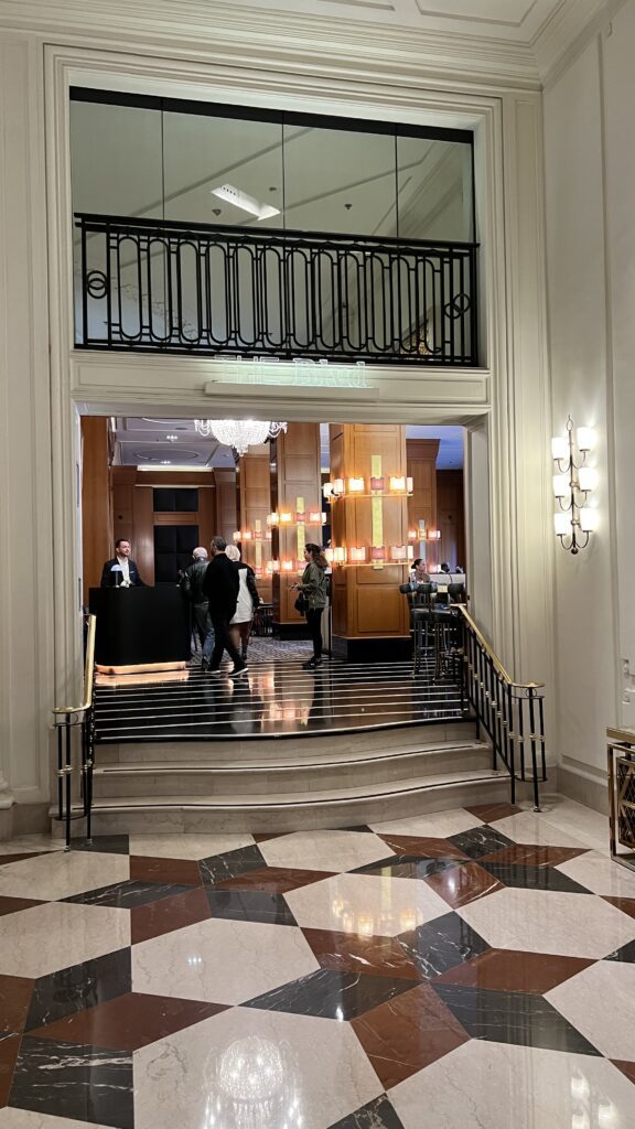 a group of people walking up a staircase in a hotel