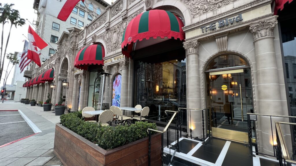 a building with a red and green awning