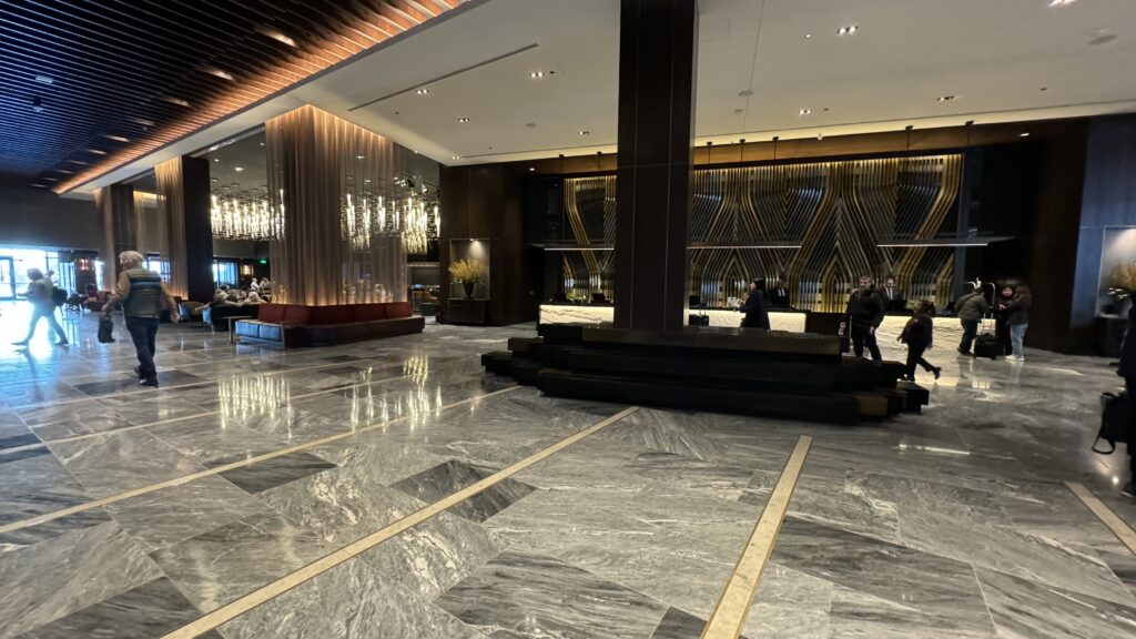 a large lobby with a marble floor and a large mirror