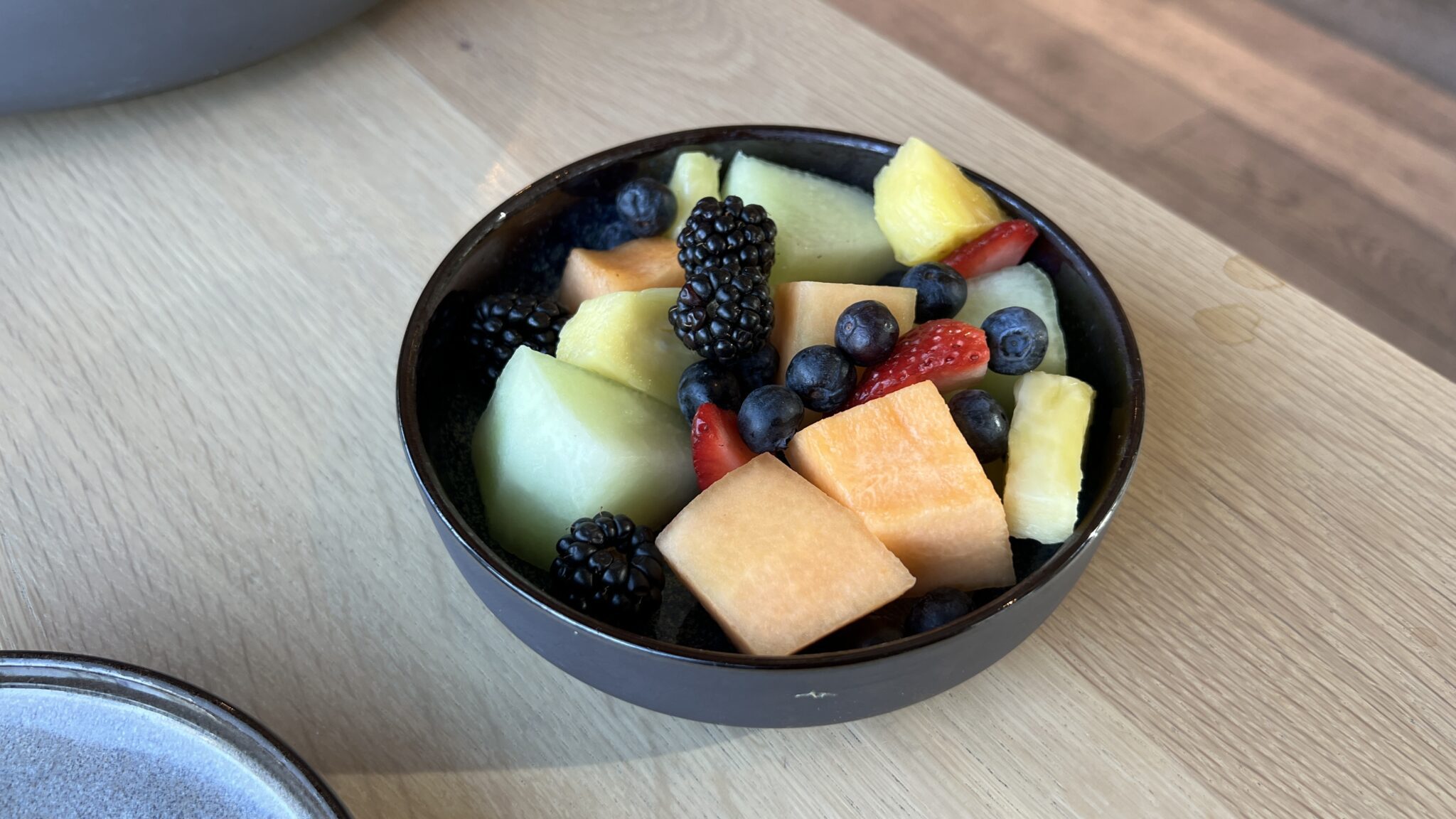 a bowl of fruit on a table
