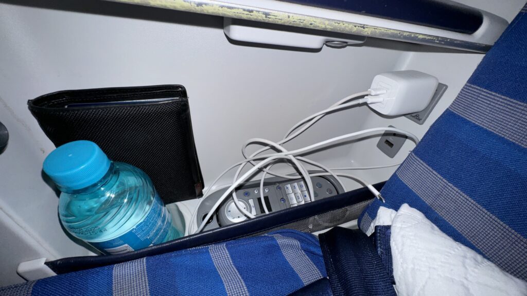 a phone and a bottle of water in a seat
