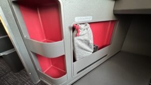 a grey bag in a red and pink bin