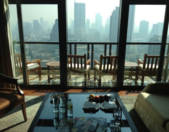 a room with a view of a city and a balcony