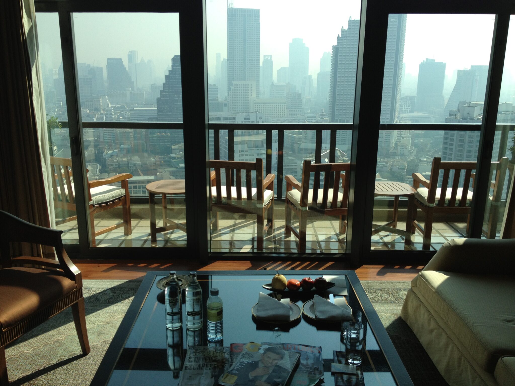 a room with a view of a city and a balcony