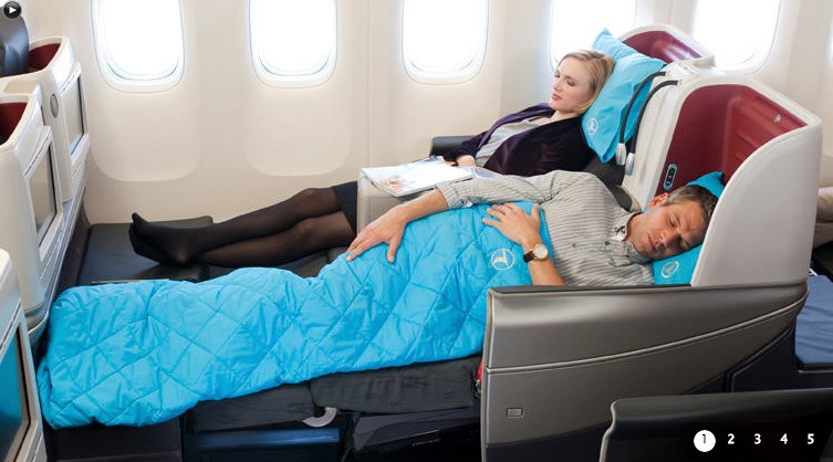a man and woman sleeping on an airplane