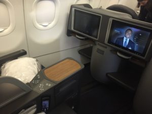 a tvs on a table in an airplane