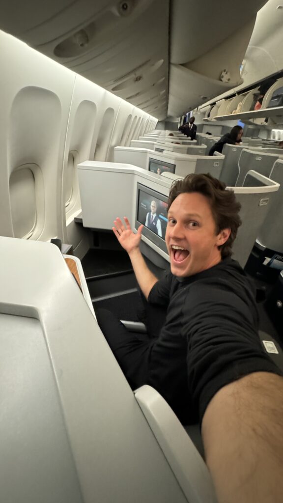 a man sitting in an airplane with his mouth open