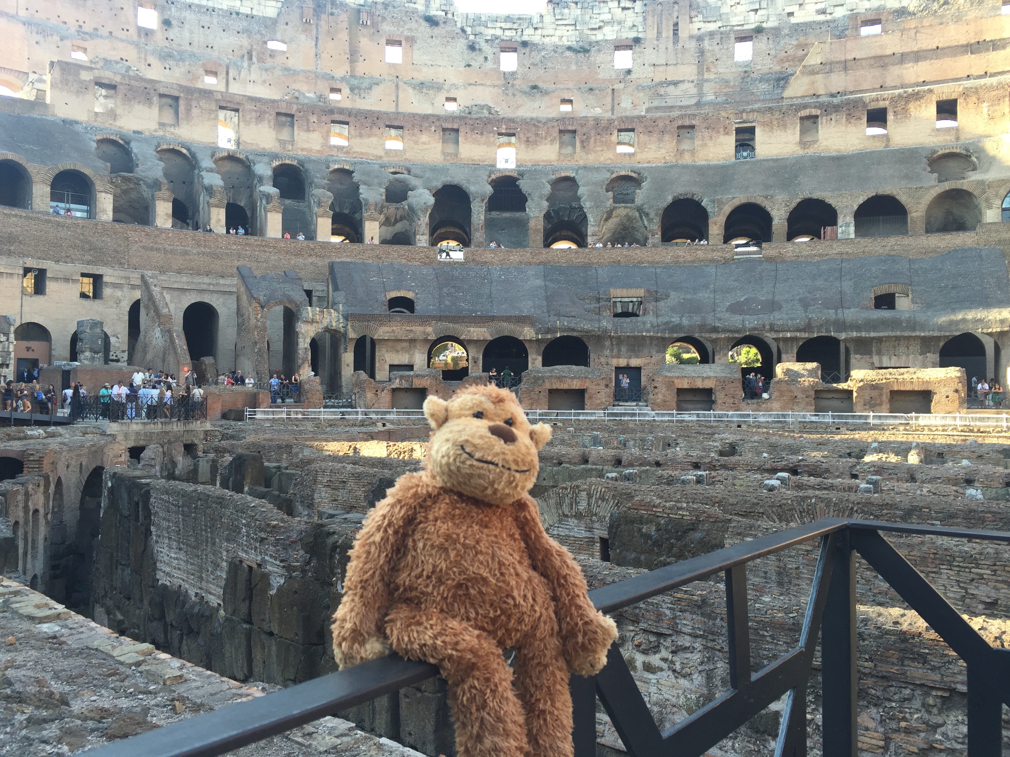 a stuffed animal on a railing in a coliseum