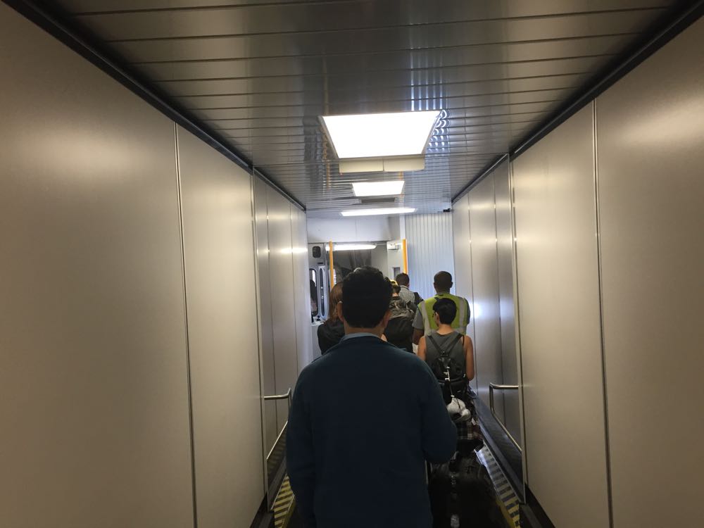 a group of people walking down a hallway