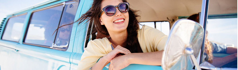 a woman wearing sunglasses smiling