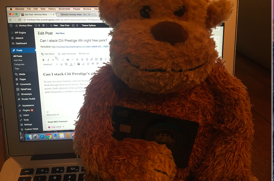 a stuffed animal in front of a laptop