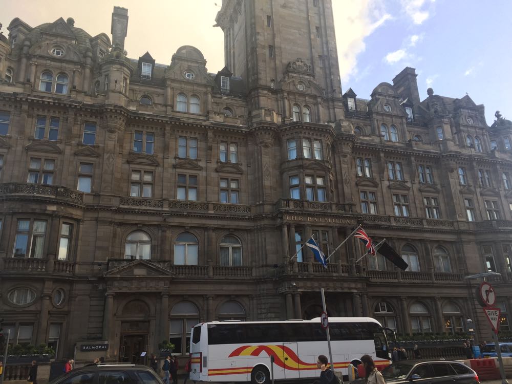 a large stone building with a bus in front of it