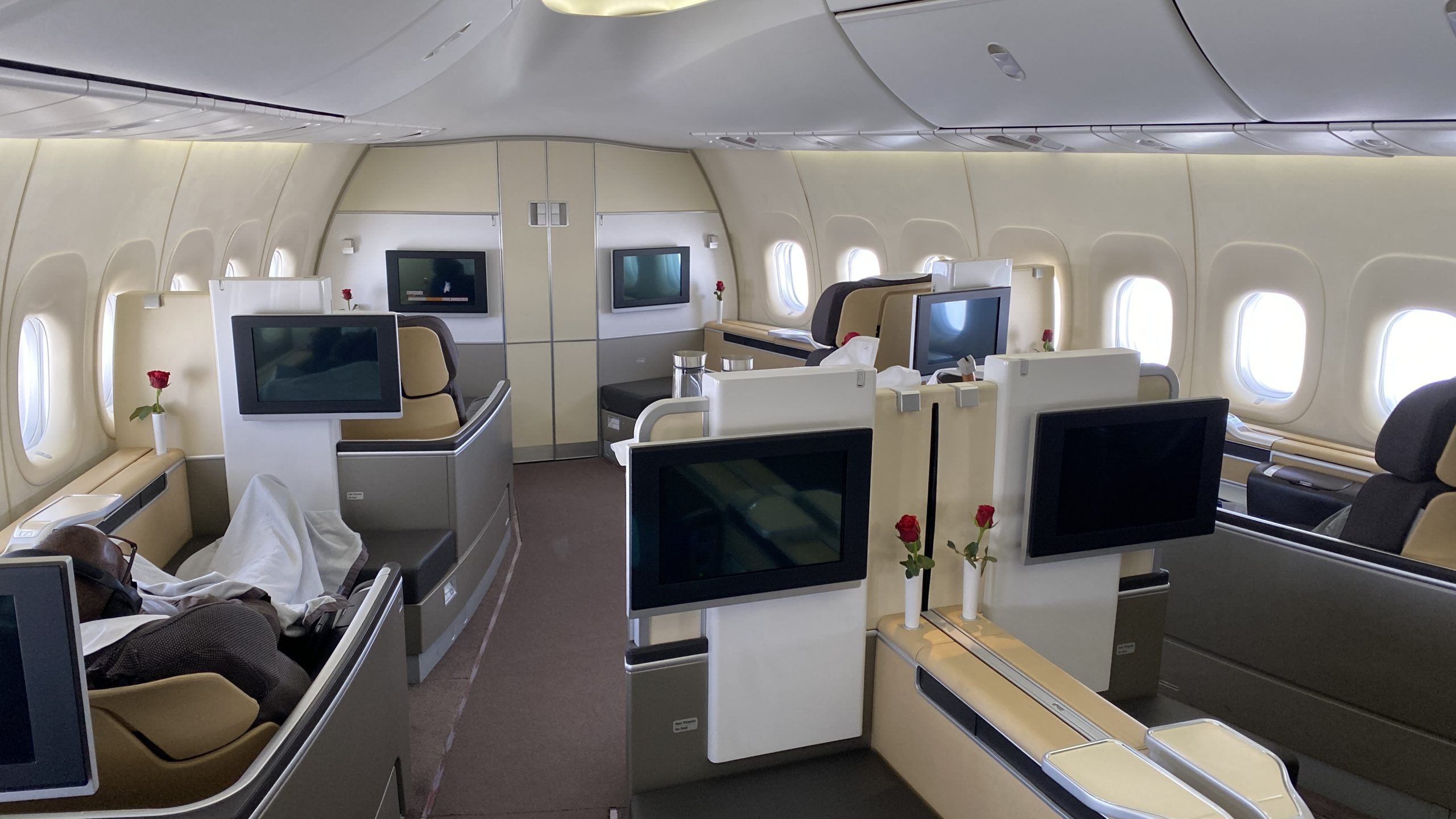 a room with tvs and windows in the middle of the plane