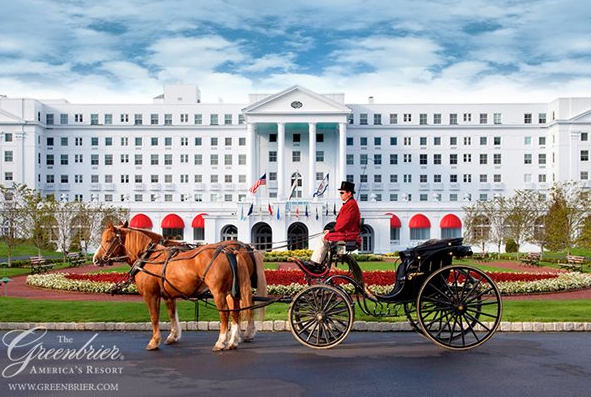 a horse carriage with a man in a hat with The Greenbrier in the background