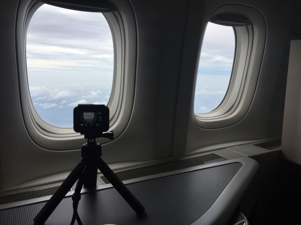 a camera on a tripod in a plane