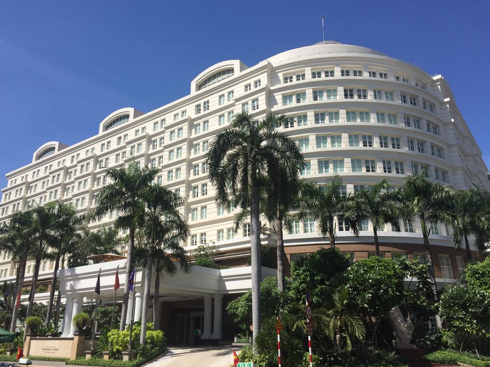 a building with palm trees and a blue sky