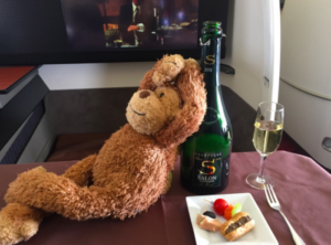 a stuffed animal next to a bottle of champagne