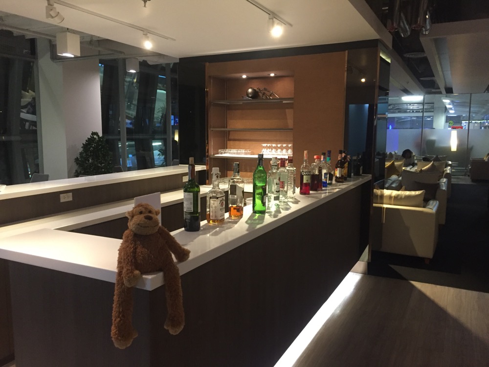 a bar with bottles of alcohol and a stuffed animal