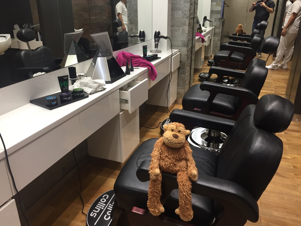 a stuffed animal on a chair in a barber shop