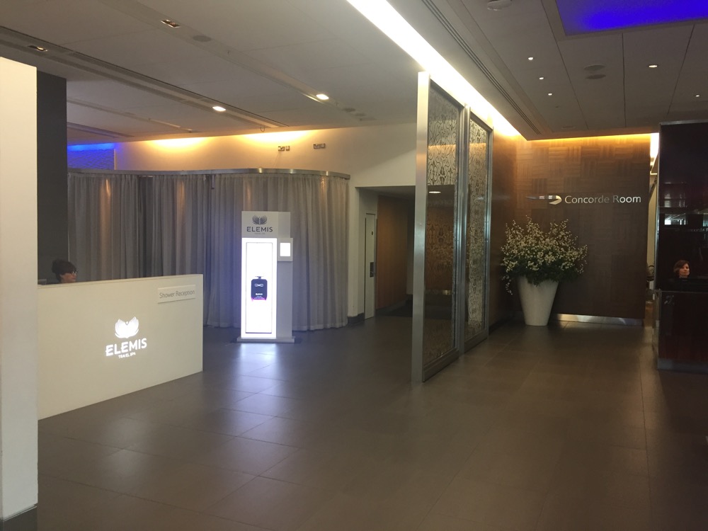 a lobby with a white sign and a glass wall