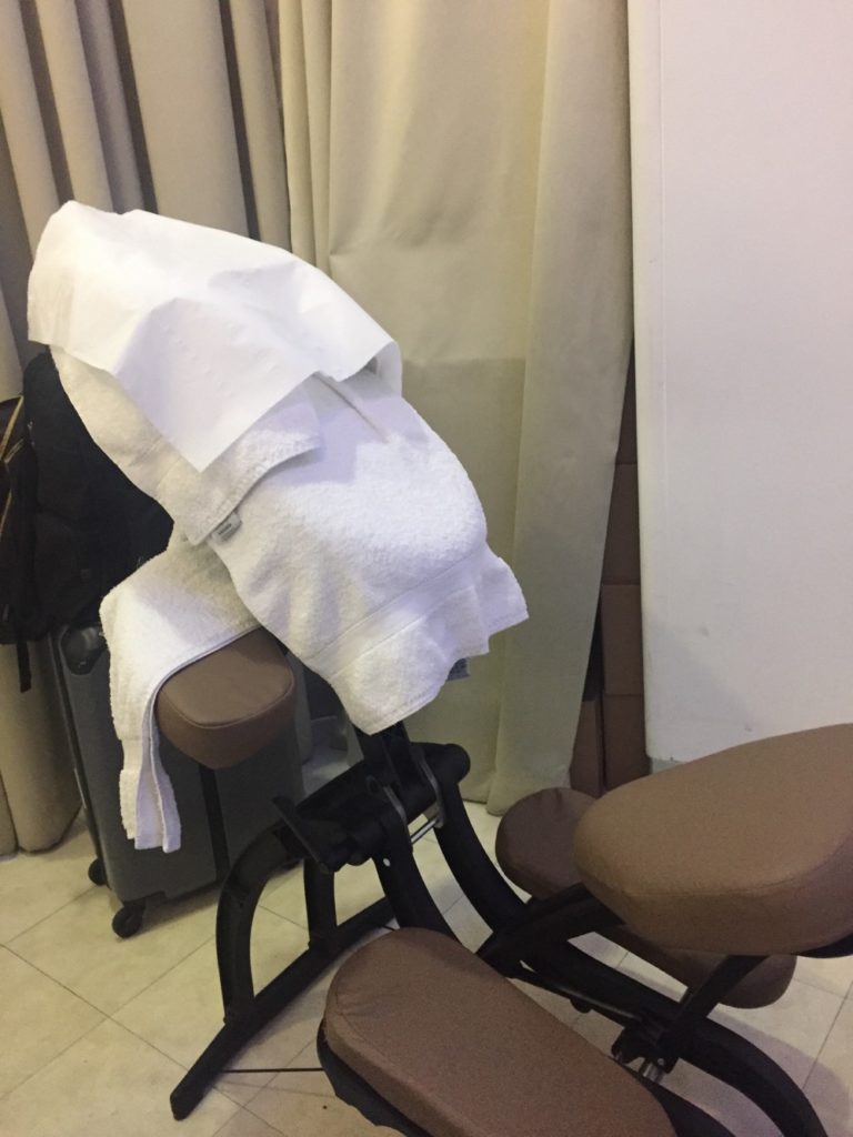 a massage chair with towels on it