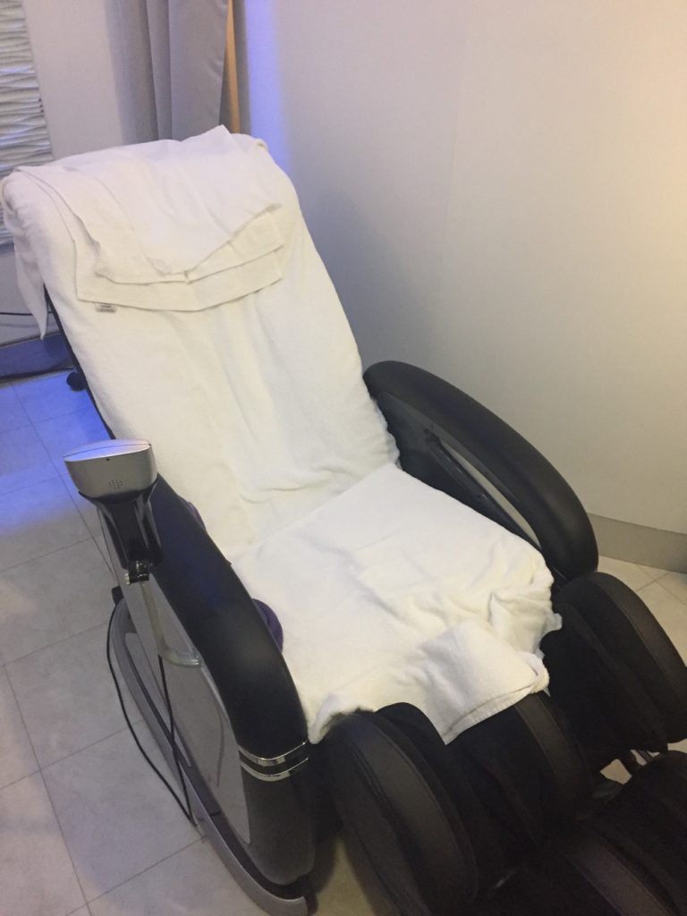 a massage chair with a towel on it