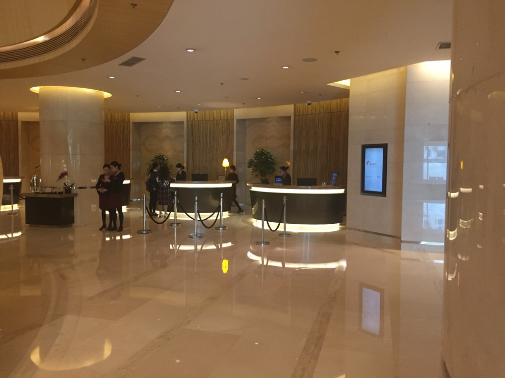 a lobby with people standing around a counter