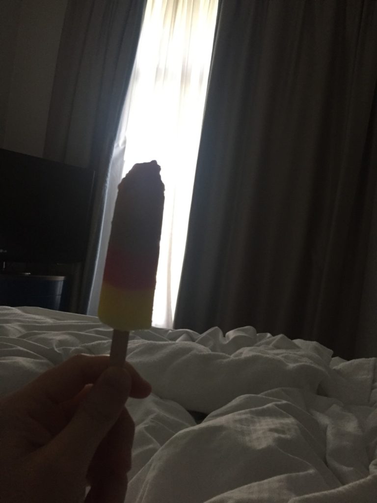 a hand holding a popsicle