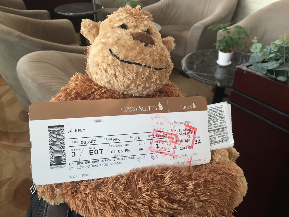 a stuffed animal holding a ticket