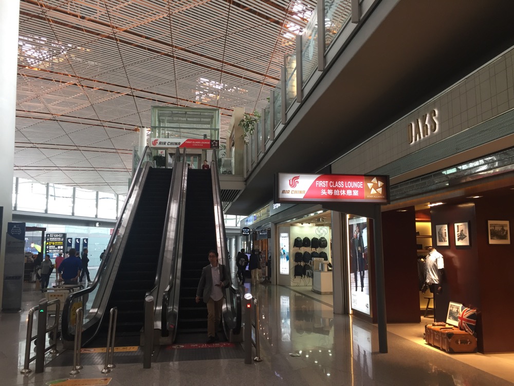 a man on an escalator in a mall