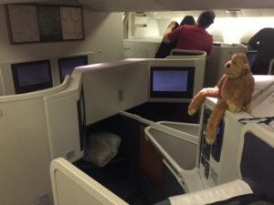 a teddy bear sitting on a desk in an airplane