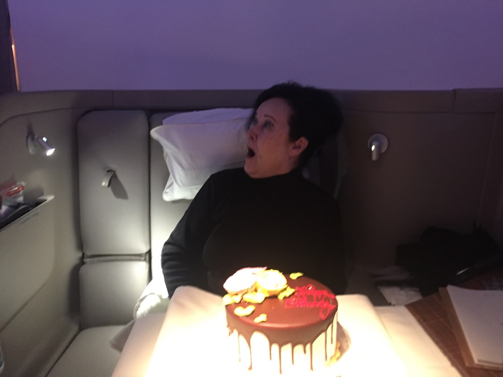 a woman sitting in a chair with a cake