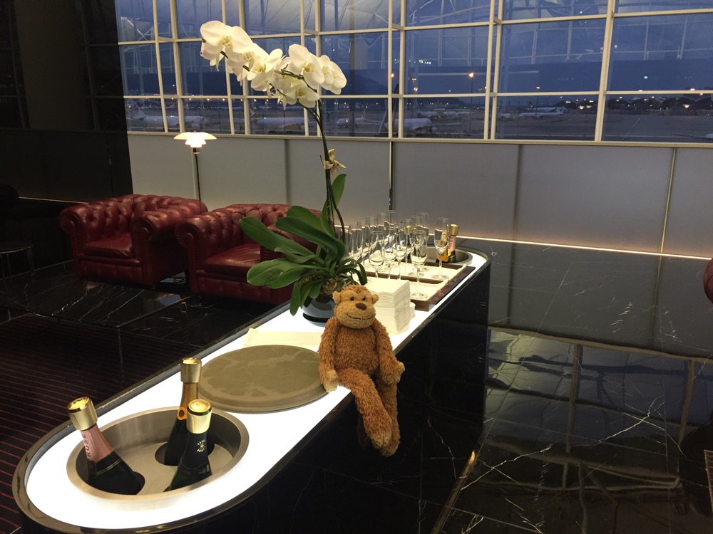 a room with a bar with a teddy bear and glasses